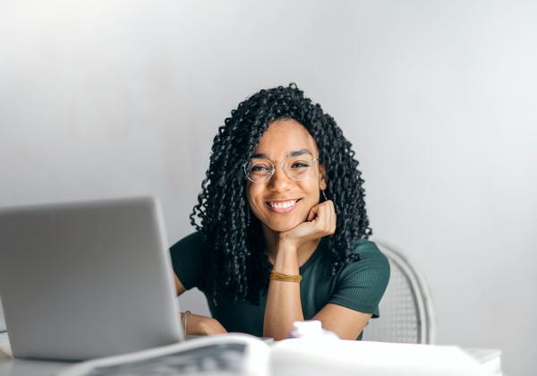 Woman smiling in front of laptop