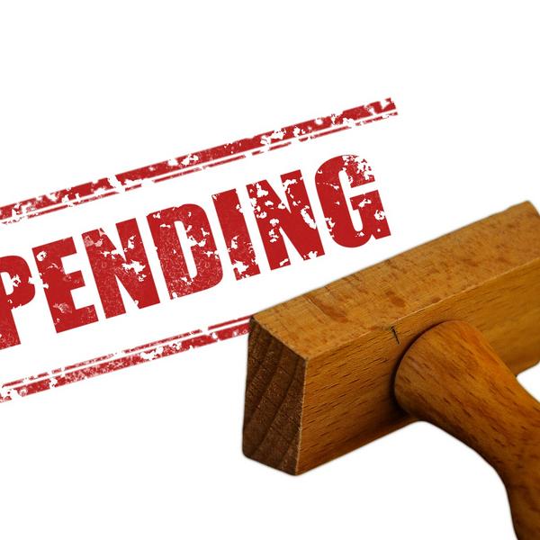 Image of stamp printing Pending in red on a page