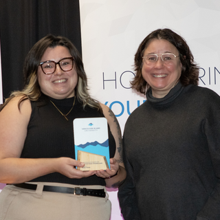 Maddy Thomas receives the award for Emerging Leader from VIU President Deb Saucier