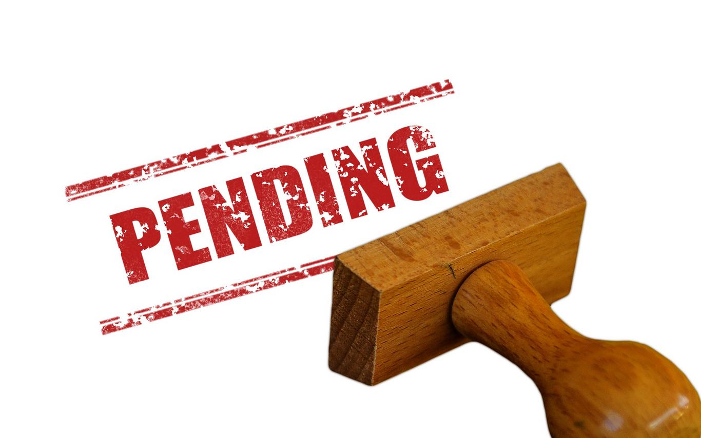 Image of stamp printing Pending in red on a page